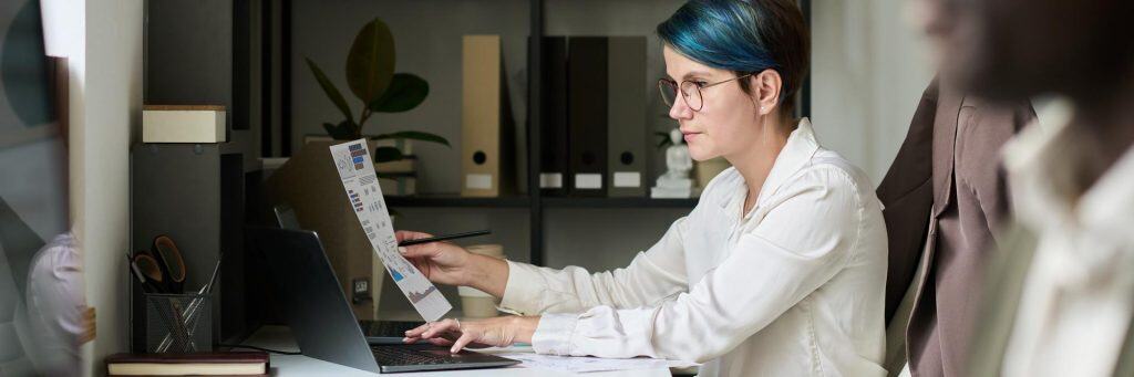 Young broker typing on laptop keypad